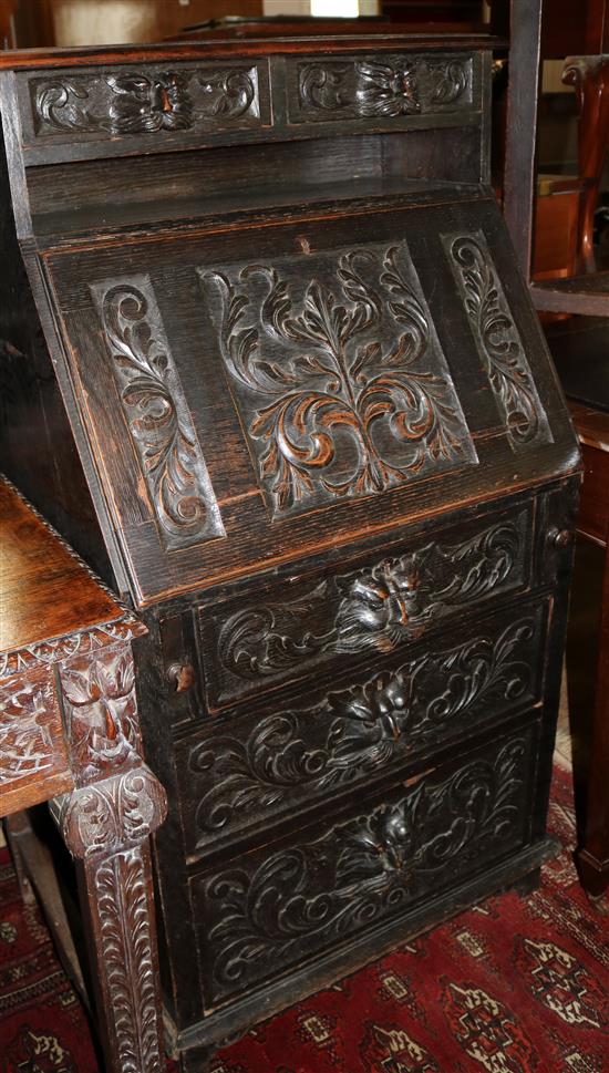 A Victorian carved oak bureau